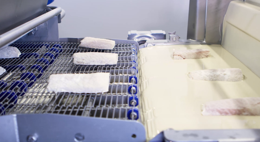Applying batter and flour to whitefish fillets with the Active Flour Applicator